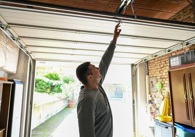 Steel Pulse technician servicing an overhead door